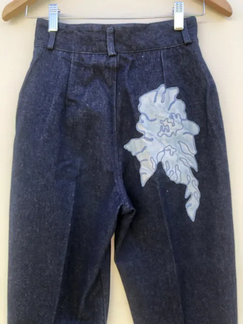 Vintage 80s high-waisted navy jeans with appliqué motifs, decals, tapered leg