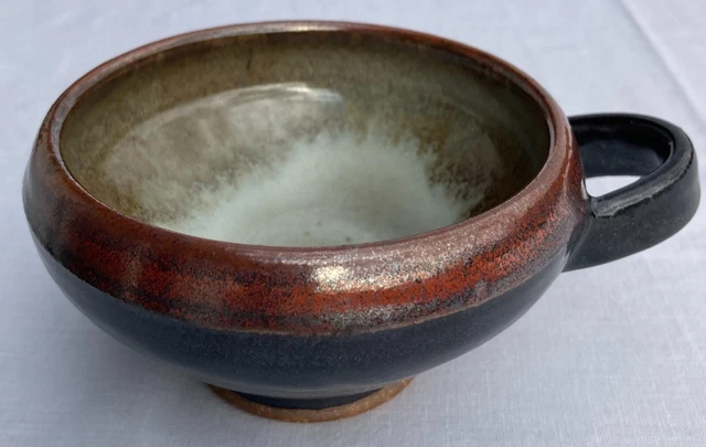 ceramic art bowl with loop, blackware bottom, black swirl glaze, and red rim