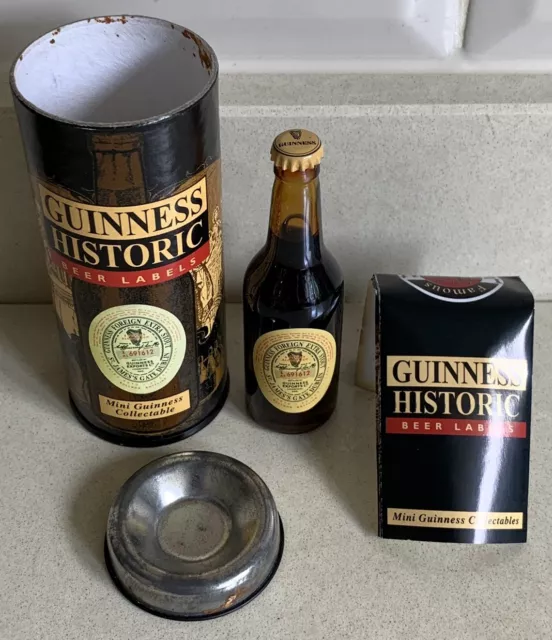 Miniature Guinness Foreign Extra Stout Beer Bottle. In Collectors Tin With Flyer