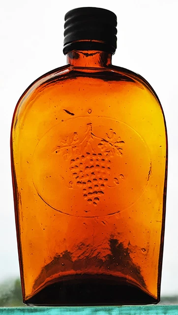 Flask, a embossed ‘Cluster of Grapes’ ‘Henry M. Coble 23 Morray St. New York'
