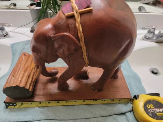 Wood Carving Of Elephant Pushing Log
