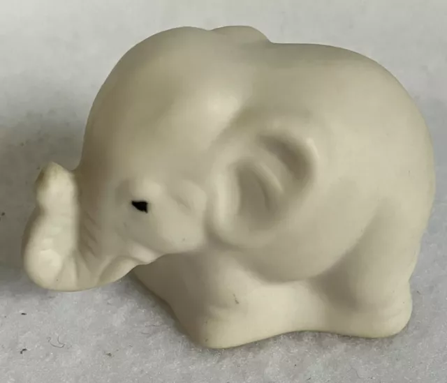 white porcelain elephant miniature figurine trunk up