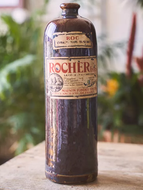 Belle ancienne bouteille en gres avec etiquete curacau triple sec ROCHER Freres