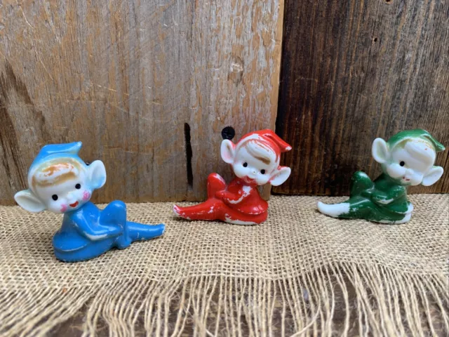 Vintage Ceramic Pixie Elf Sitting Figurine Mid Century 2” Set Of 3-Red/Blue/Gree