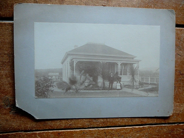ANTIQUE CABINET PHOTO -  ONE STORY COTTAGE HOUSE with SMALL PALM TREES EXTERIOR