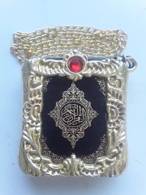 The Holy Quran  A plastic SuspEnsion Holder  And A Metal Chain Very Small Size