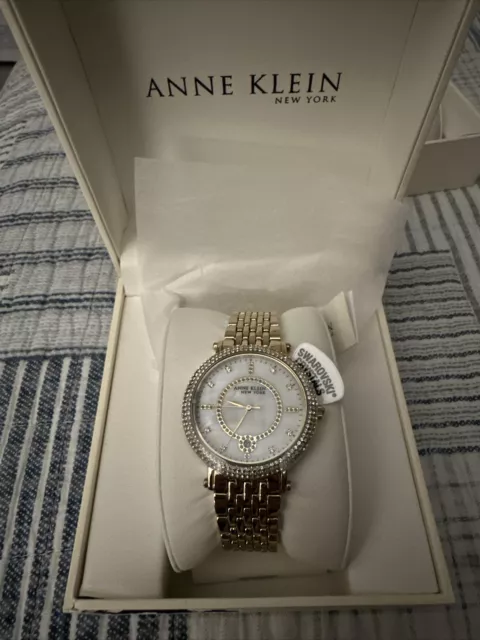 Anne Klein Women's 12/2312MPGB Crystal Accented Gold Tone Watch w/ MOP Dial