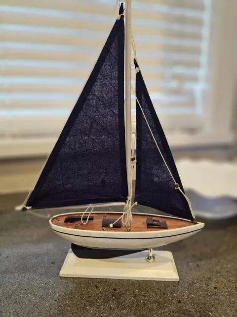 Vintage Sailboat Model with Blue Cloth Sails