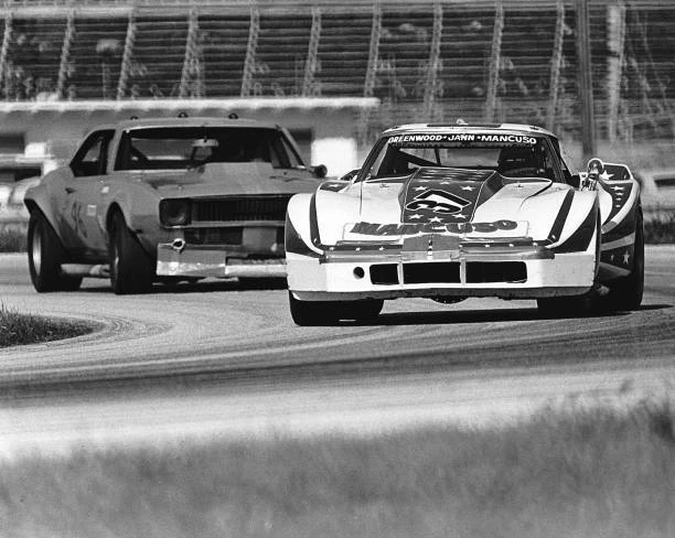 JOHN GREENWOOD'S CHEVROLET Corvette Leads A Chevrolet Camaro Old