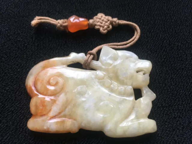 A Chinese celadon and russet jade pendant, 19th/20th century hand carved Foo Dog 2