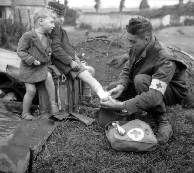 WWII B&W Photo Canadian Medic Treats Injured French Child  WW2 France  / 1246