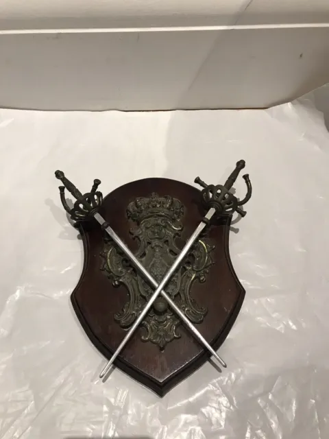 Antique cast metal medieval heraldic shield with swords