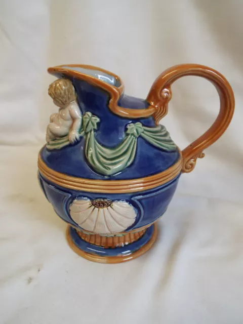 Contempory majolica jug pitcher with cherub and shells.