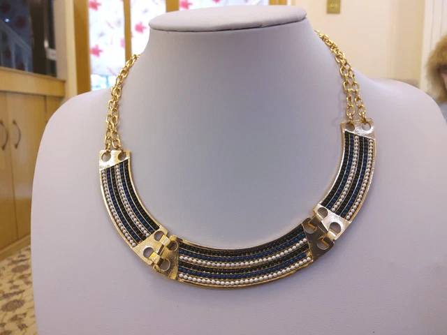 Brand new gold tone necklace with sections of black white and blue beads