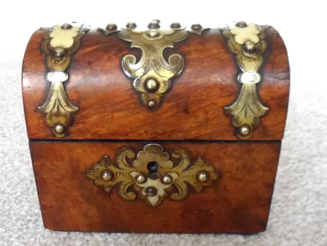 Antique dome topped wooden box with brass coloured metal strapping. Dainty size.