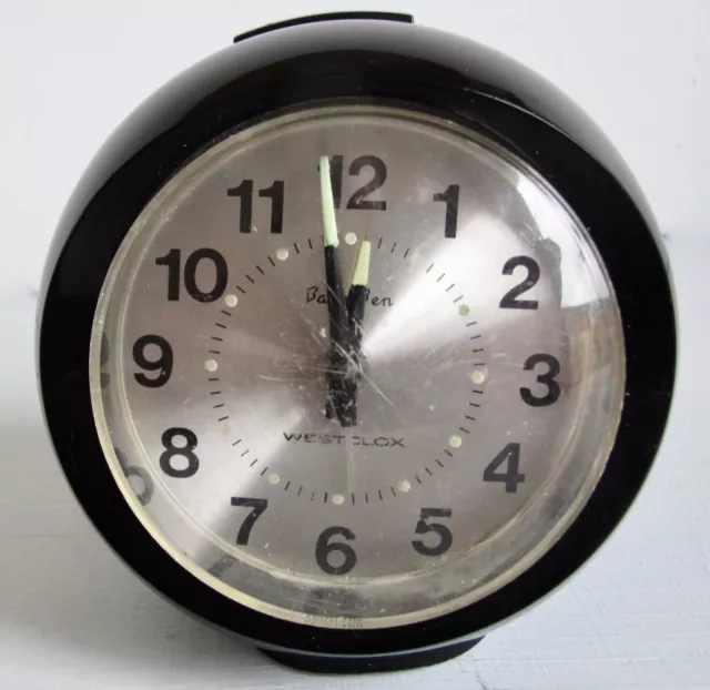 Vintage Westclox black plastic spherical “Baby Ben” mechanical alarm clock.