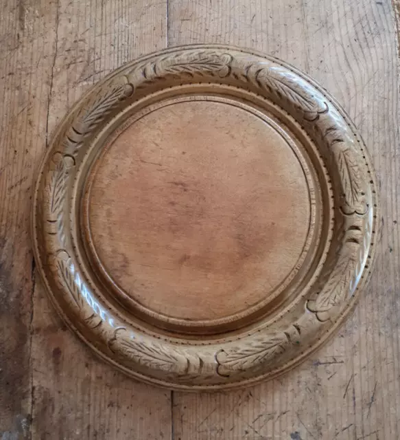 An excellent antique sycamore breadboard with foliate perimeter carving.