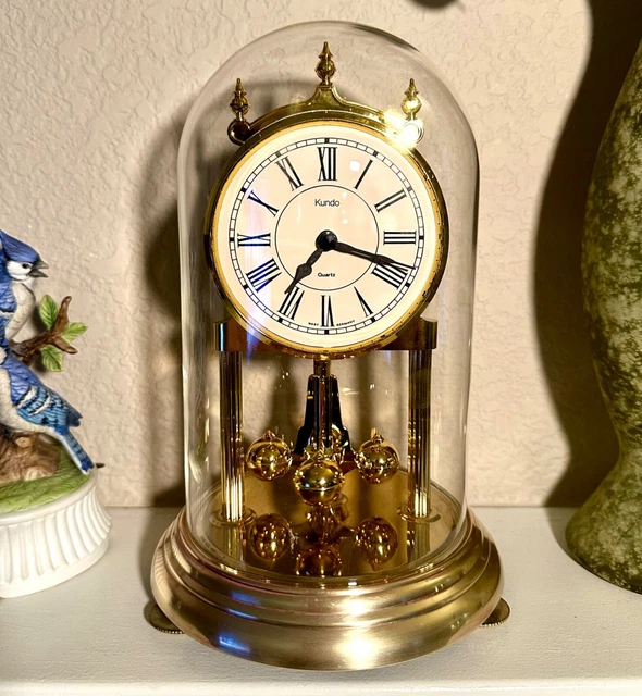 MC KUNDO BATTERY operated anniversary clock with glass dome. German