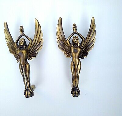 Golden Angel statue with torch and opened wings in female hand brass door handle