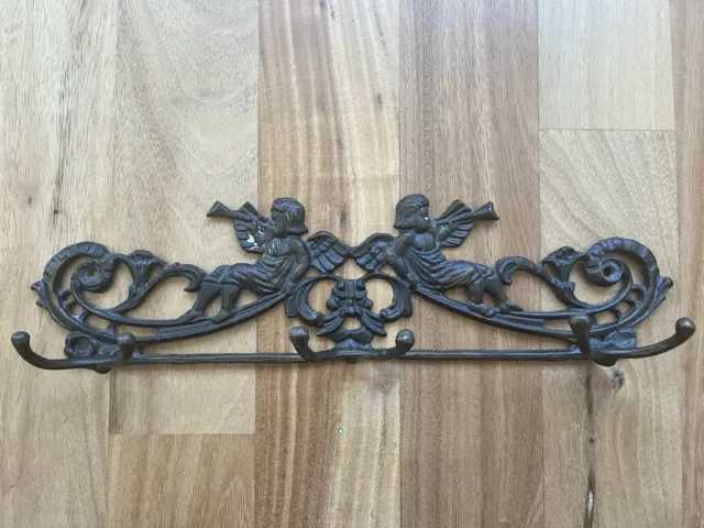 Antique cast iron Victorian cherub angel wall coat rack, six hooks three prongs