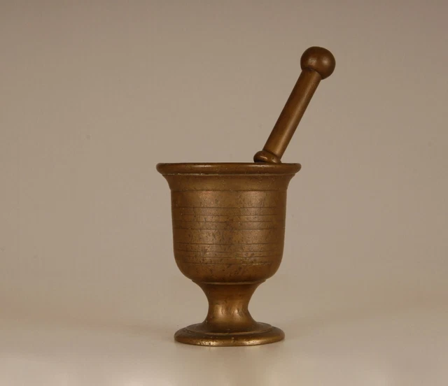 An antique continental 19th century Greek bronze mortar and pestle heavy cast