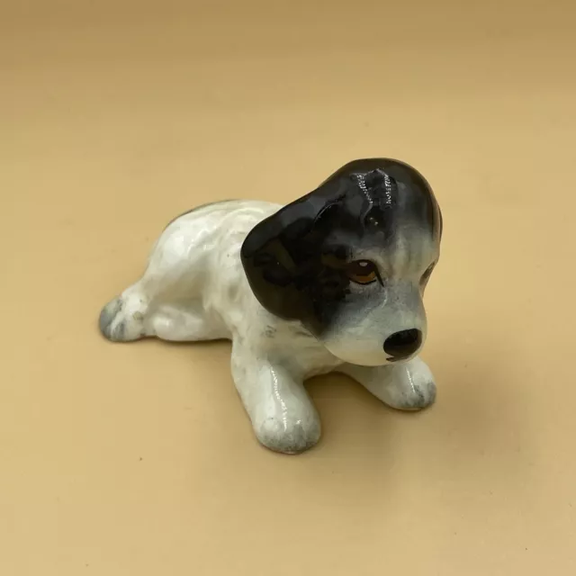 Vintage Sylvac Black and white lying down spaniel dog